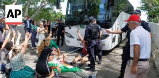 Protesters block bus believed to be carrying Iran women's