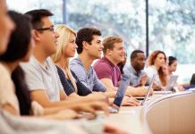 A diverse group of students attentively listening in a classroom setting