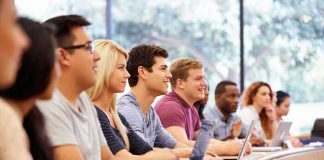 A diverse group of students attentively listening in a classroom setting