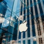 MAJOR Shift: Apple Bets Everything on New CEO Apple store with glass facade and city reflections.