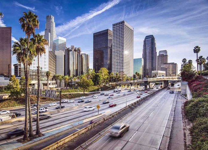 Downtown cityscape with skyscrapers and highway traffic.