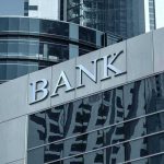 Bank Access Upheaval: Trump’s Surprise Directive Bank building with reflective glass windows.