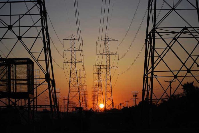 709070596 Transmission towers at sunset.
