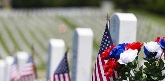 Old Guard Transforms Arlington in Mere Hours American flags and flowers placed at graves in a cemetery