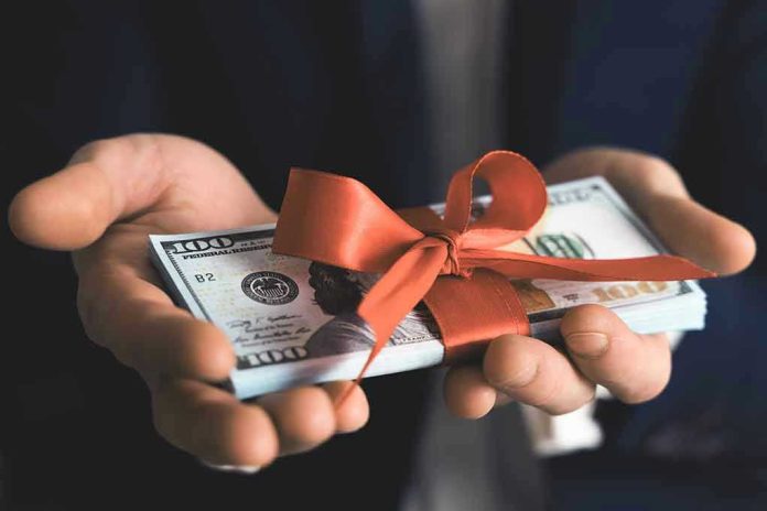 1690384846-1 Hands holding stack of hundred-dollar bills with ribbon.