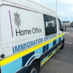 Bank Crackdown Targets Cartel Cash White immigration enforcement van parked by roadside