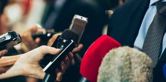 Situation Room Tapes? Reporters Under Fire Interview microphones pointed at a person in suit.