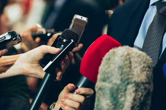 461773729 Interview microphones pointed at a person in suit.