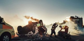 Florida Mayhem: Anti-Christ Claim, Helicopter Chaos Emergency responders at an overturned, smoking car on a roadway