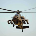 Military Apache helicopter flying in the sky