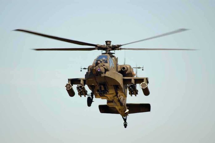 shutterstock_11072761 Military Apache helicopter flying in the sky