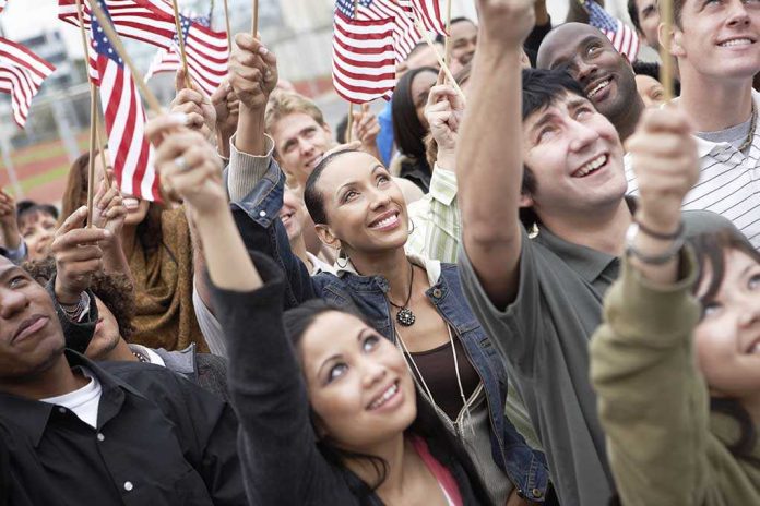shutterstock_144639302 A diverse group of people joyfully waving American flags in celebration