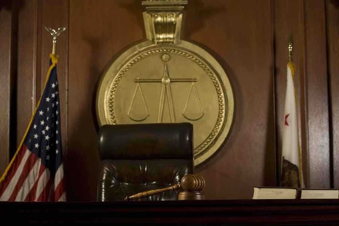 A judges bench in a courtroom with a gavel and legal symbols