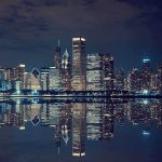 Bears Bolt? Illinois Just Got Humiliated Nighttime view of a city skyline with reflections on water