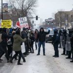 Kids Show Star Sparks ICE Uproar Protesters facing police during a demonstration in winter