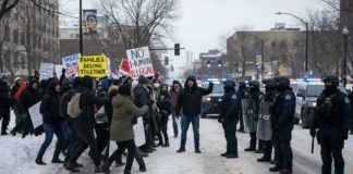Kids Show Star Sparks ICE Uproar Protesters facing police during a demonstration in winter