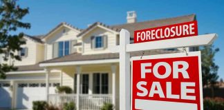Foreclosure sign in front of a house for sale