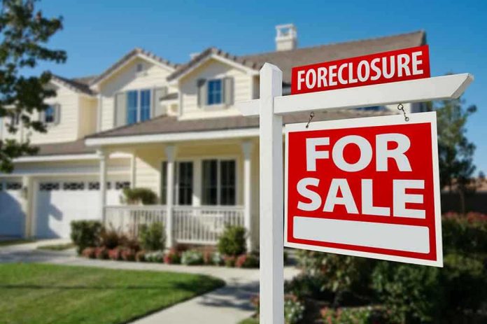 shutterstock_50097061 Foreclosure sign in front of a house for sale