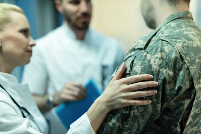 1408562144 Doctors comforting a person in military uniform