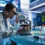 Harvard Twist: Tiny Mineral Rattles Alzheimer’s Playbook Scientist using a microscope in a modern laboratory