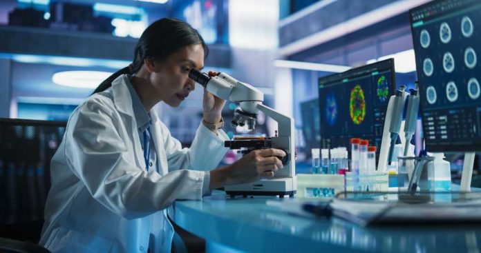scientist-using-microscope2456036981jpg Scientist using a microscope in a modern laboratory
