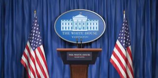 Two Wars, One Deal — What’s Trump Trading? White House press podium with microphones and two American flags