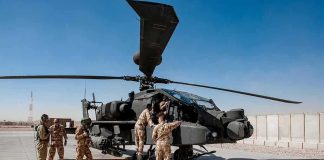 Iran Strikes U.S. Base—Troops Killed Soldiers inspect a military attack helicopter on a tarmac
