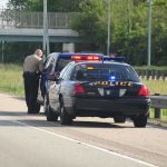 Romo Stopped, Reputation Hammered — For What? Police officer conducting a traffic stop on a highway