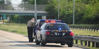 Romo Stopped, Reputation Hammered — For What? Police officer conducting a traffic stop on a highway