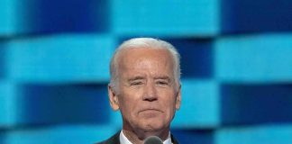 Man in suit speaking at a podium