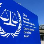 International Criminal Court sign with scales emblem outside modern building