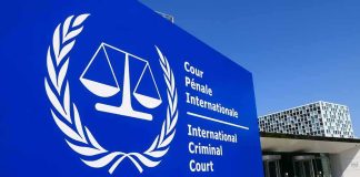 International Criminal Court sign with scales emblem outside modern building