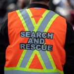 Mystery In Paradise: Mom Vanishes Search and rescue worker in orange reflective vest