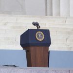 Trump Axes Rules, Then Pardons? Critics Howl Podium with a microphone and presidential seal in front of steps