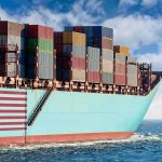 Major Military Punishment Looms In Red Sea Cargo ship bow loaded with stacked containers at sea