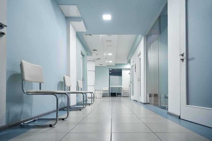 shutterstock_1903368601 Empty medical clinic hallway with chairs