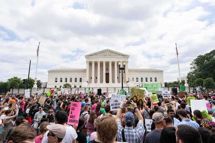 shutterstock_2171255255 Crowd of protesters outside a neoclassical courthouse holding signs