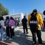 School Overdoses Explode — Silence Follows Students standing outside a high school entrance