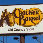 Cracker Barrel’s Woke Rebrand Backfires — CEO Out Cracker Barrel roadside sign with logo against blue sky