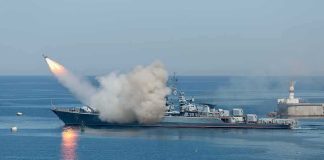 Warship launching a missile at sea