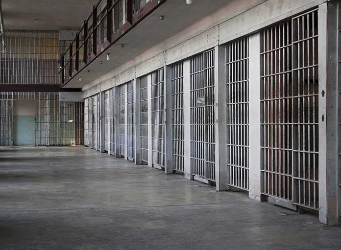 prison cell block with metal barred doors