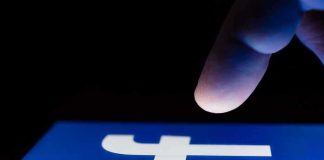 Record Meta Penalty — And It’s Not Over finger hovering over Facebook app icon on a smartphone screen