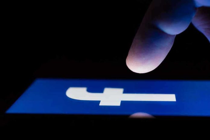 shutterstock_1087265159 finger hovering over Facebook app icon on a smartphone screen