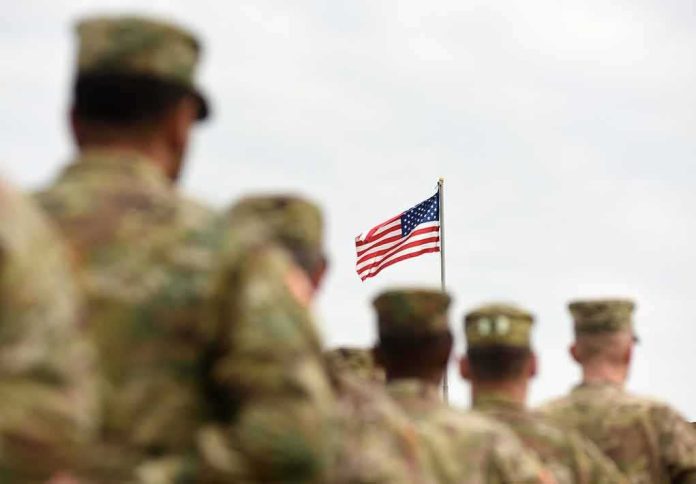 shutterstock_1170998920 U.S. flag flying above a formation of soldiers in uniform