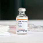 MMR vaccine vial on a white surface