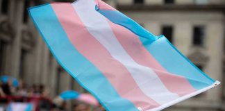 Transgender pride flag waving at a parade