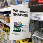 City Groceries Demand Papers Now Shelf sign in a grocery aisle showing SNAP EBT acceptance
