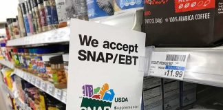 City Groceries Demand Papers Now Shelf sign in a grocery aisle showing SNAP EBT acceptance