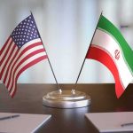 Payback Play: Trump Corners Tehran United States and Iran desk flags on a stand