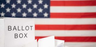 Iowa Snub Sparks Midwest Fury Ballot box with papers in front of an American flag